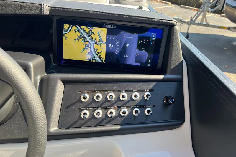 Slide: The Image of Alera M23Q 2026 boat dashboard with Simrad navigation display and control panel. - 9