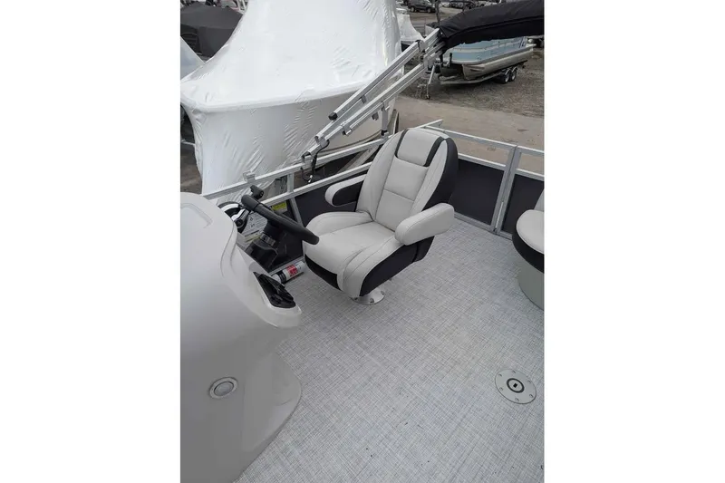 Slide: The Image of 2025 South Bay 16FC SE S Entertainment boat interior with captain's chair and steering console. - 16