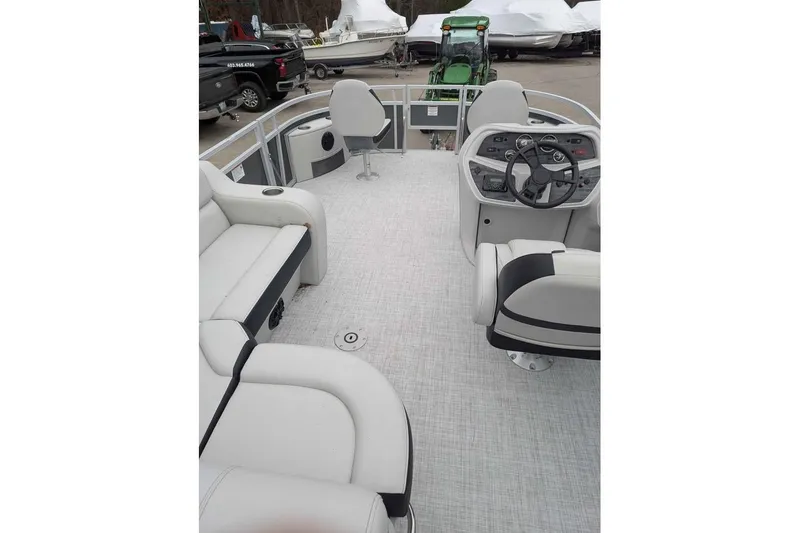 Slide: The Image of 2025 South Bay 16FC SE S Entertainment pontoon boat interior with seating and steering console. - 8