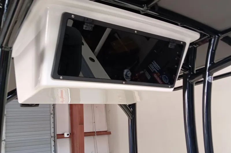 Slide: The Image of 2026 May-Craft 245 Offshore CC boat console with black frame and storage compartment. - 10