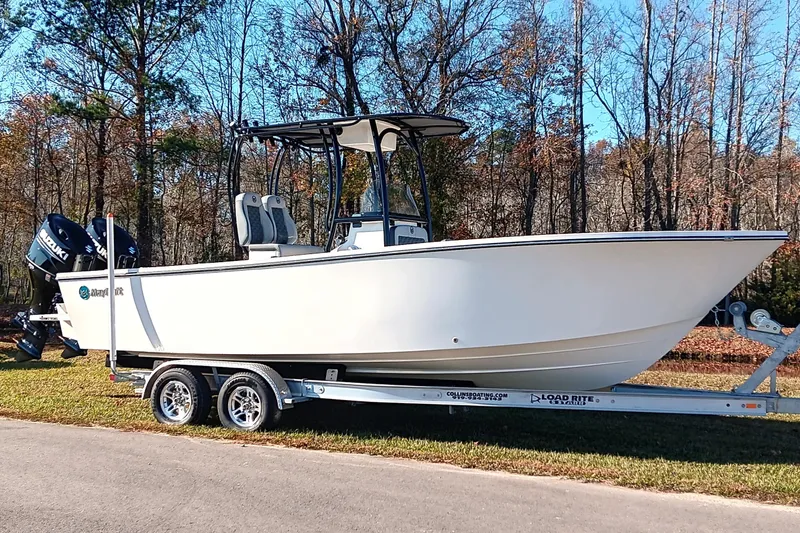 Slide: The Image of 2026 May-Craft 245 Offshore CC boat on trailer, parked outdoors. - 2