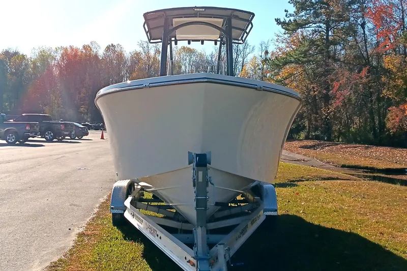 Slide: The Image of 2026 May-Craft 245 Offshore CC boat on trailer, parked outdoors in sunny setting. - 3