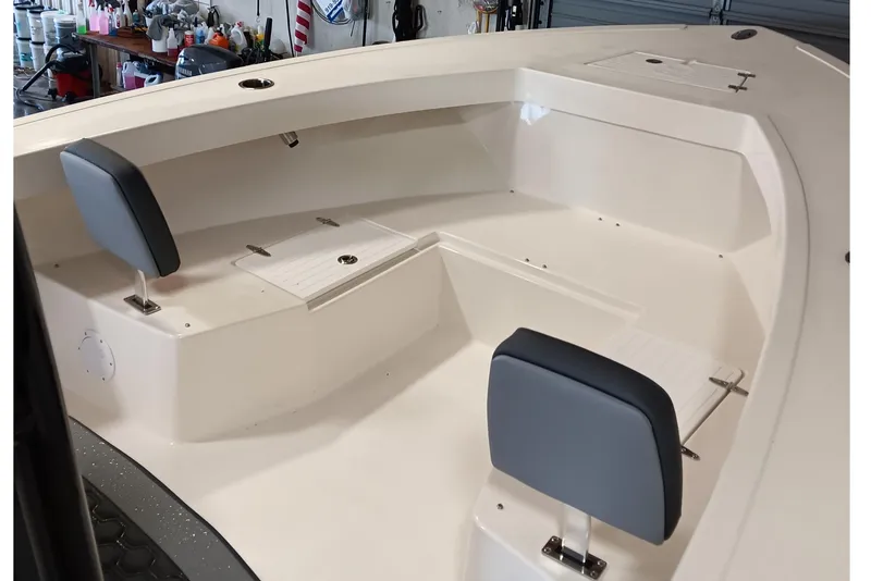 Slide: The Image of 2026 May-Craft 245 Offshore CC boat interior with seating and storage compartments. - 6