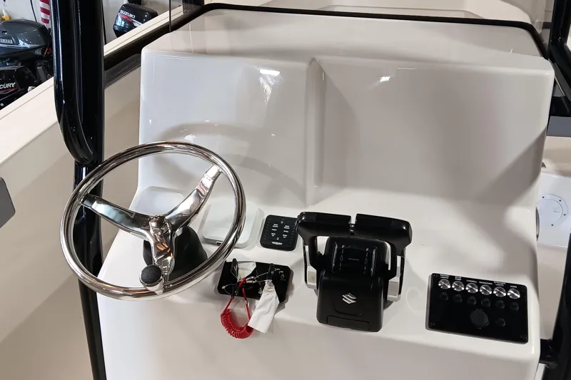 Slide: The Image of Steering console of 2026 May-Craft 245 Offshore CC boat with controls and switches. - 9