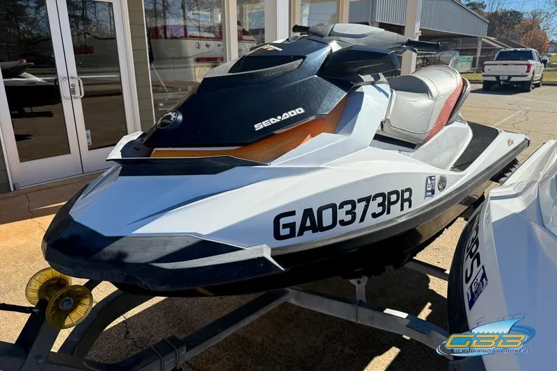Slide: The Image of 2011 Sea-Doo GTI 130 jet ski on trailer, parked outside a building. - 3