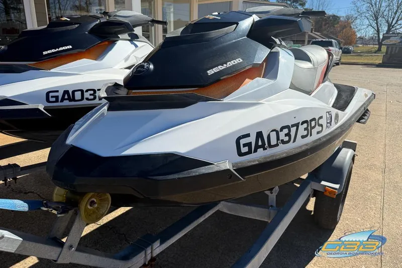 Slide: The Image of 2011 Sea-Doo GTI 130 jet ski on trailer, parked outdoors. - 4