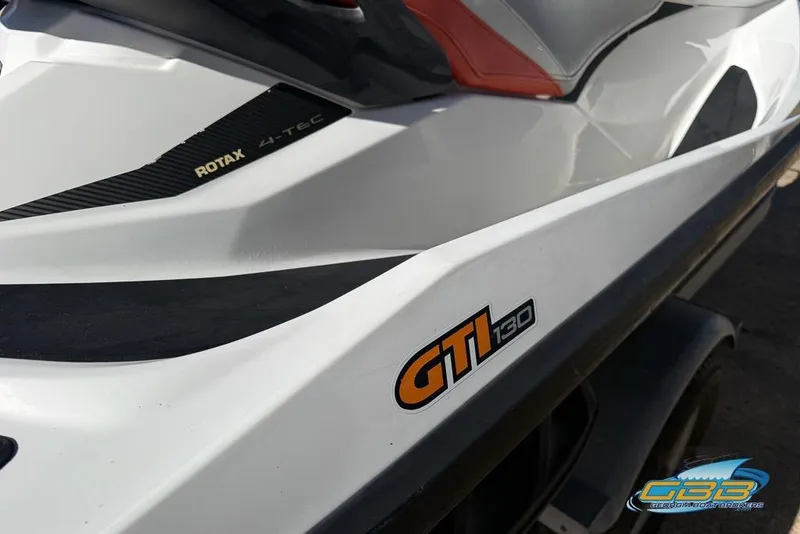 Slide: The Image of 2011 Sea-Doo GTI 130 jet ski with Rotax 4-TEC engine branding. - 7