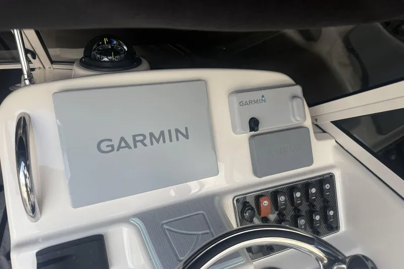 Slide: The Image of 2023 Grady-White Freedom 215 dashboard with Garmin navigation system and controls. - 11