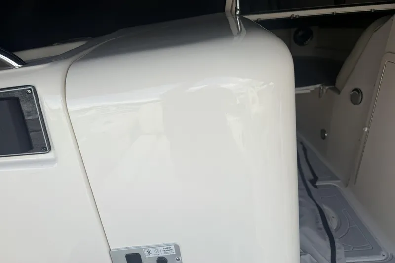 Slide: The Image of 2023 Grady-White Freedom 215 boat interior, showcasing sleek white design and modern features. - 13