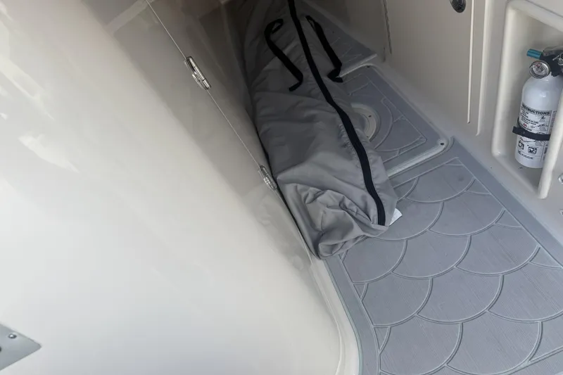 Slide: The Image of 2023 Grady-White Freedom 215 interior storage with fire extinguisher and bag. - 14