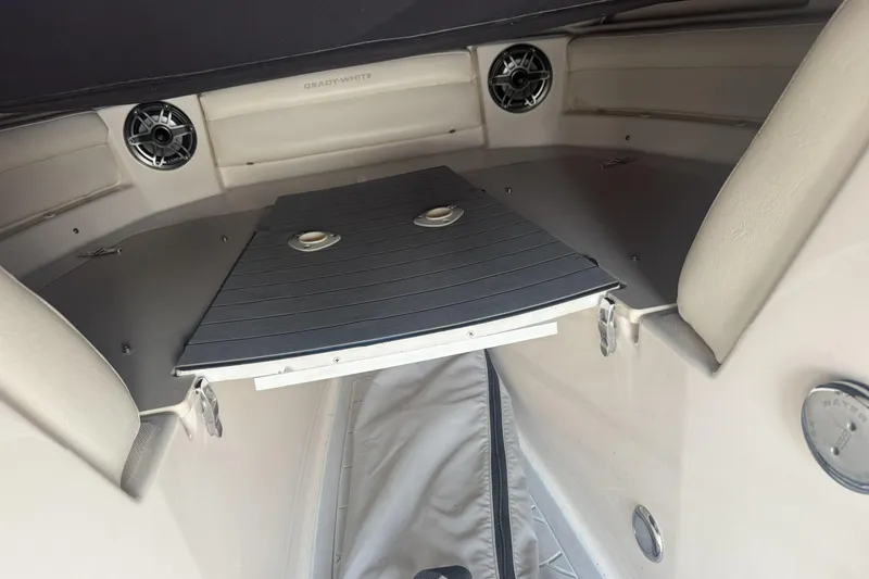 Slide: The Image of 2023 Grady-White Freedom 215 boat interior with speakers and seating area. - 15