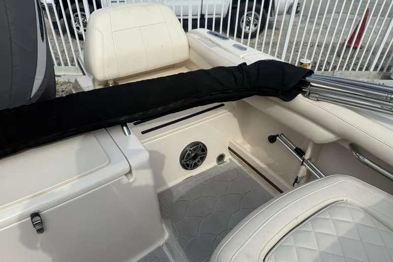 Slide: The Image of 2023 Grady-White Freedom 215 boat interior with white seating and speaker. - 24