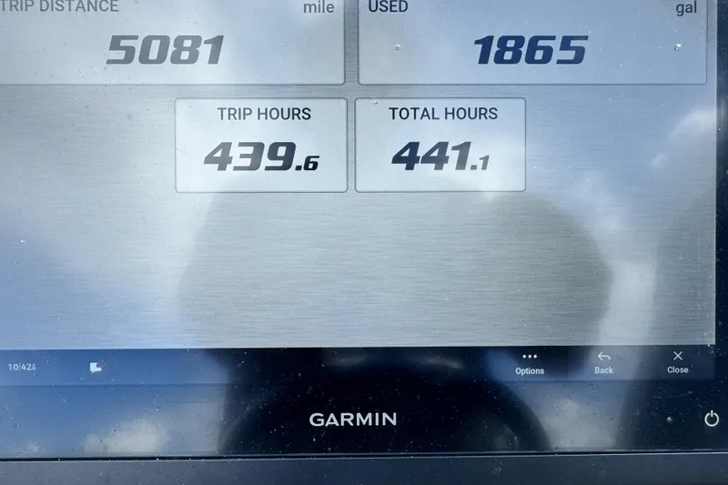 Slide: The Image of Garmin display showing trip data: 5081 miles, 1865 gallons, 439.6 trip hours, 441.1 total hours. Grady-White Freedom 215. - 7