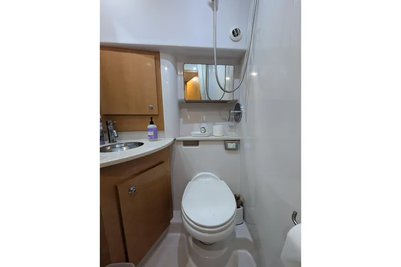 Slide: The Image of 2009 Four Winns V458 yacht bathroom with modern fixtures and wooden cabinetry. - 15