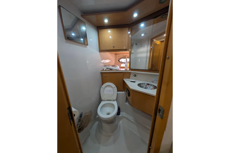 Slide: The Image of 2009 Four Winns V458 yacht bathroom with toilet, sink, and mirror. - 16