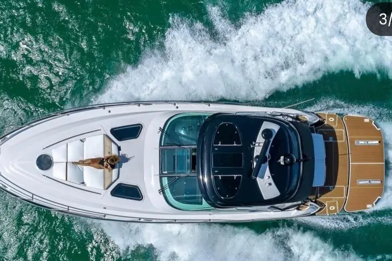 Slide: The Image of Overhead view of 2009 Four Winns V458 yacht cruising on water. - 2