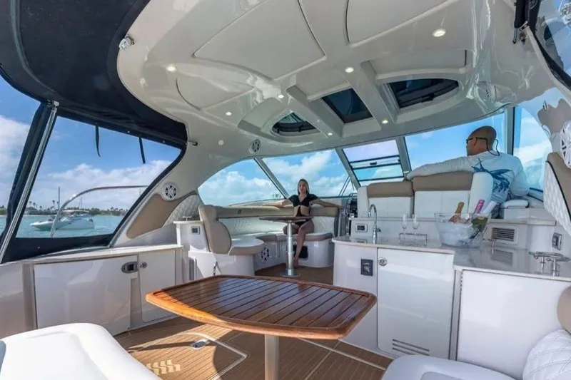Slide: The Image of Luxurious 2009 Four Winns V458 yacht interior with seating, table, and ocean view. - 4