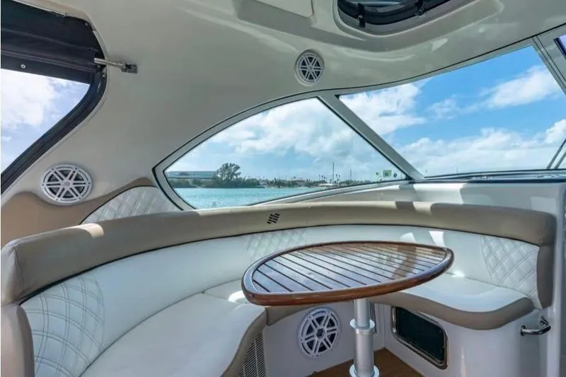 Slide: The Image of Interior of 2009 Four Winns V458 yacht with elegant seating and wooden table. - 5