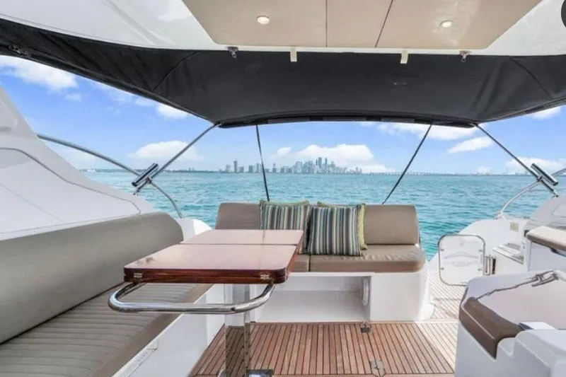 Slide: The Image of 2009 Four Winns V458 yacht interior with city skyline view, featuring seating and table. - 7