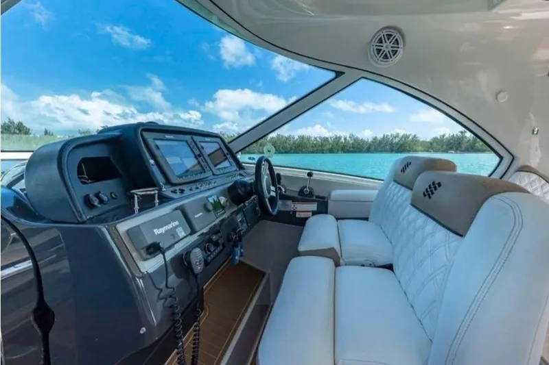 Slide: The Image of 2009 Four Winns V458 yacht interior with modern dashboard and luxurious seating. - 8