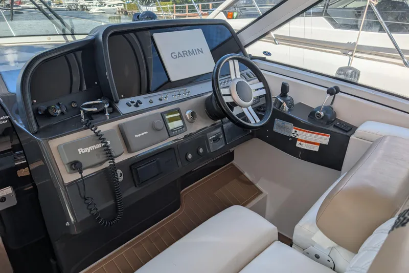 Slide: The Image of 2009 Four Winns V458 boat cockpit with Garmin and Raymarine navigation systems. - 9