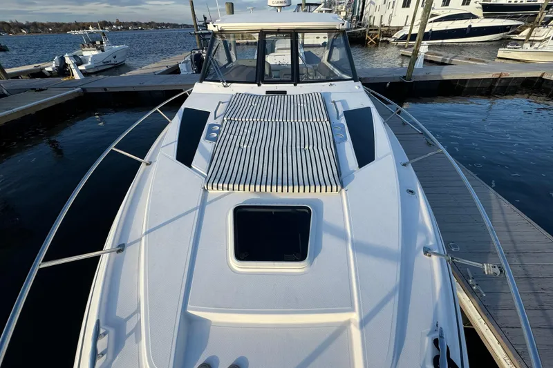 Slide: The Image of 2017 Regal 35 Sport Coupe docked at marina, showcasing sleek design and spacious deck. - 15