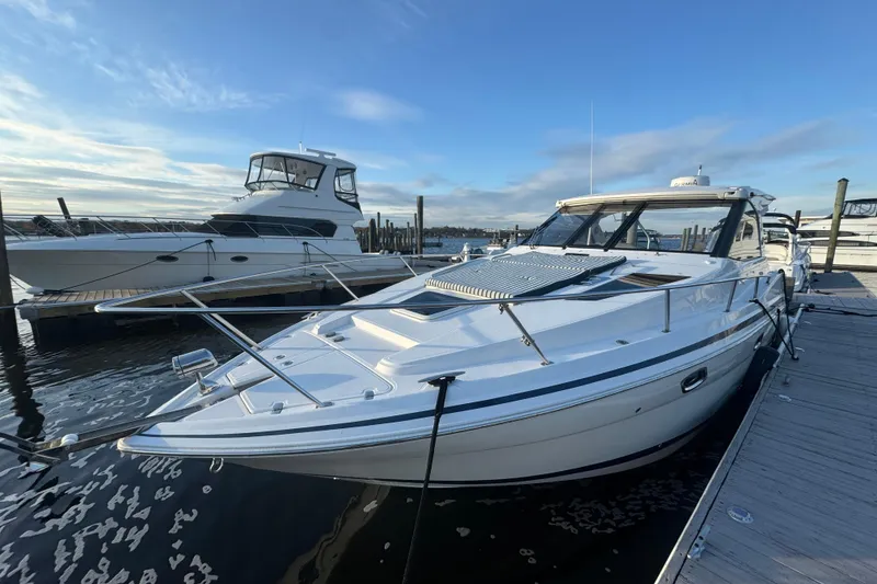 Slide: The Image of 2017 Regal 35 Sport Coupe docked at marina under clear blue sky. - 16