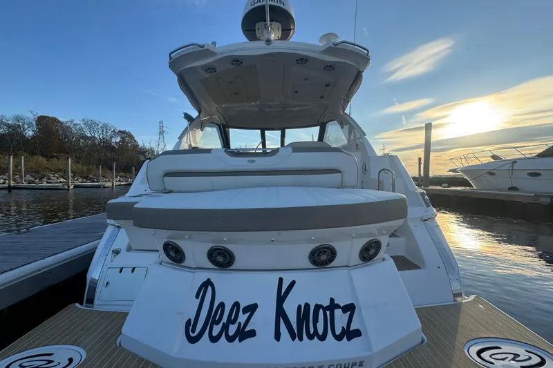 Slide: The Image of 2017 Regal 35 Sport Coupe yacht docked at sunset, rear view. - 17