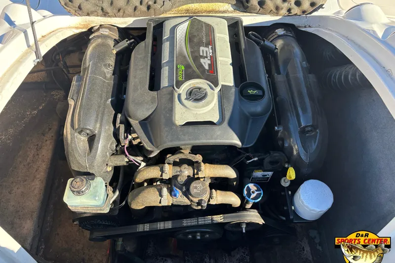 Slide: The Image of Engine compartment of a 2014 Starcraft 2000 IO Limited boat, featuring a 4.3 MPI motor. - 10