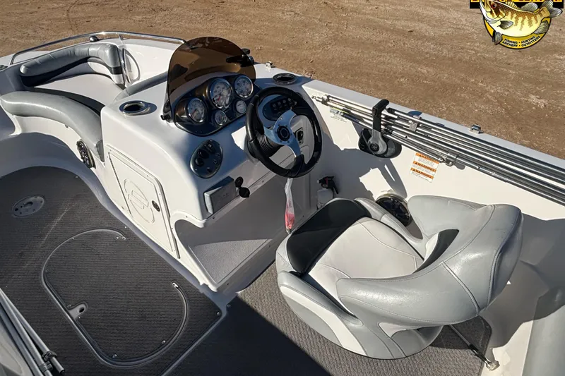 Slide: The Image of 2014 Starcraft 2000 IO Limited boat interior with steering console and seating. - 7