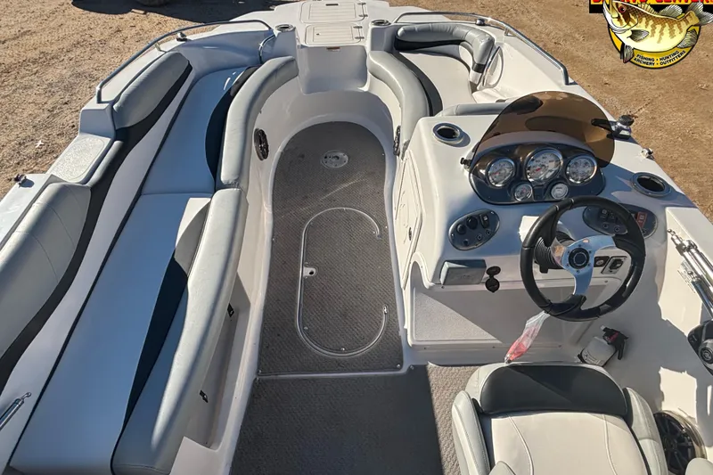 Slide: The Image of 2014 Starcraft 2000 IO Limited boat interior with steering wheel and seating. - 8