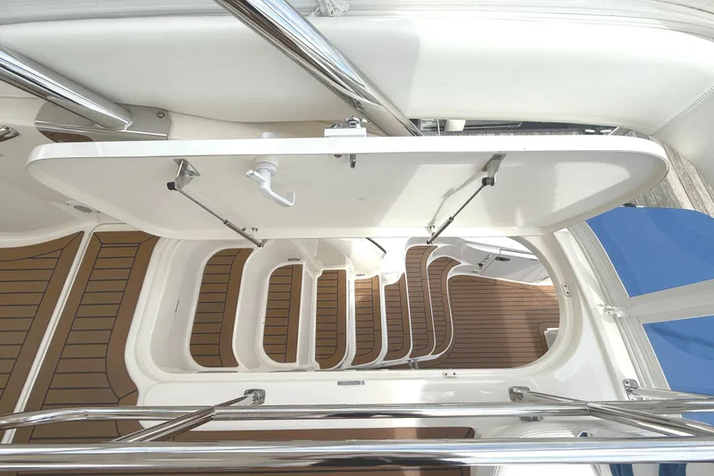 Slide: The Image of 2007 Sea Ray 58 Sedan Bridge yacht interior with open hatch and wooden flooring. - 11