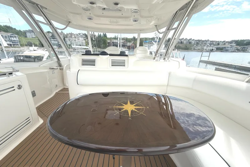 Slide: The Image of Luxurious 2007 Sea Ray 58 Sedan Bridge yacht interior with elegant seating and polished table. - 16