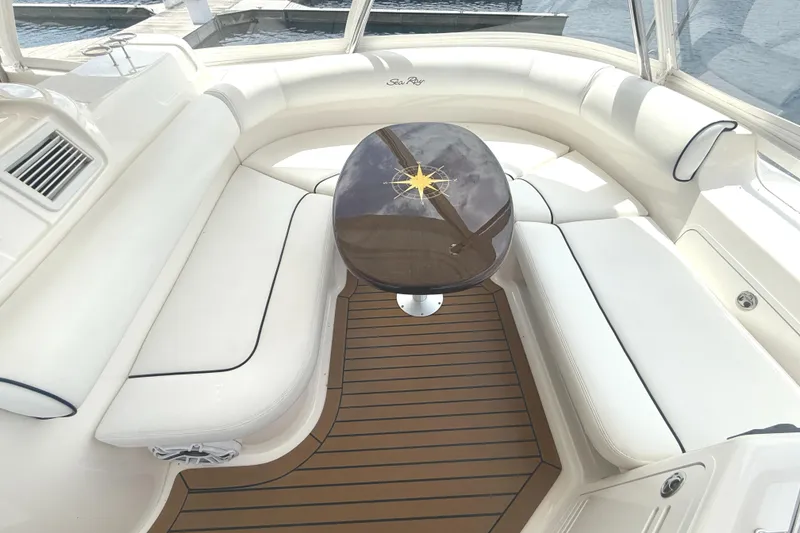 Slide: The Image of Luxurious interior of 2007 Sea Ray 58 Sedan Bridge with elegant seating and wooden table. - 17