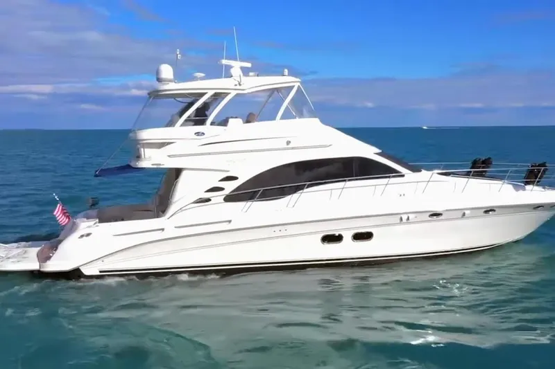 Slide: The Image of 2007 Sea Ray 58 Sedan Bridge yacht cruising on open water. - 2