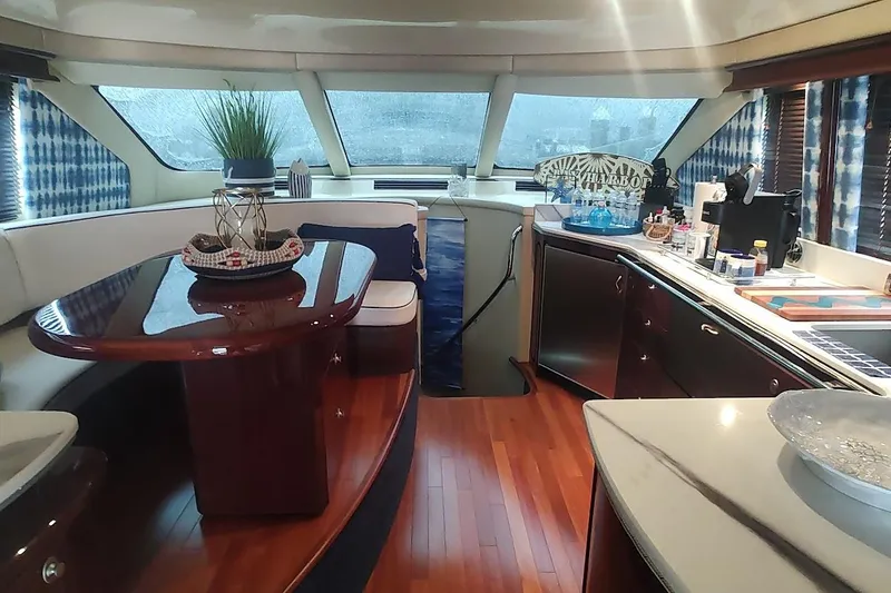 Slide: The Image of Luxurious interior of a 2007 Sea Ray 58 Sedan Bridge yacht with elegant wood finishes. - 23