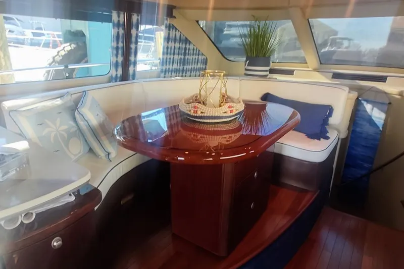 Slide: The Image of Luxurious interior of 2007 Sea Ray 58 Sedan Bridge yacht with elegant dining area. - 24