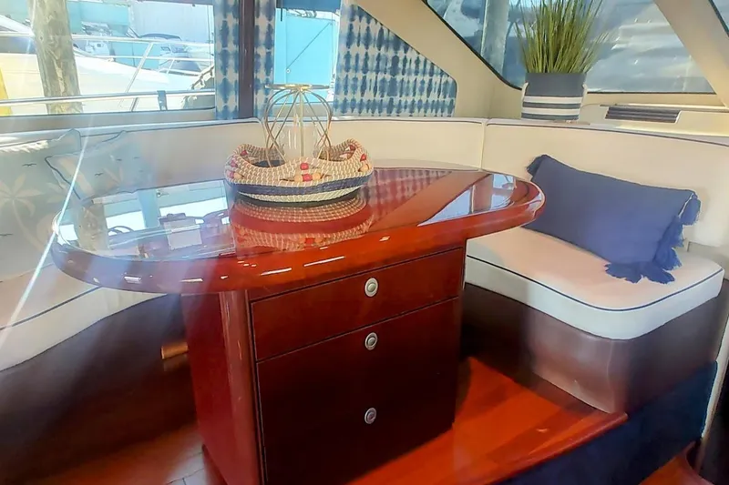 Slide: The Image of Luxurious interior of 2007 Sea Ray 58 Sedan Bridge with elegant wood table and seating. - 25