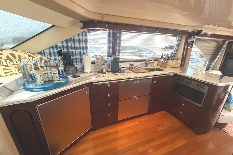 Slide: The Image of Luxurious kitchen interior of 2007 Sea Ray 58 Sedan Bridge yacht with modern amenities. - 28