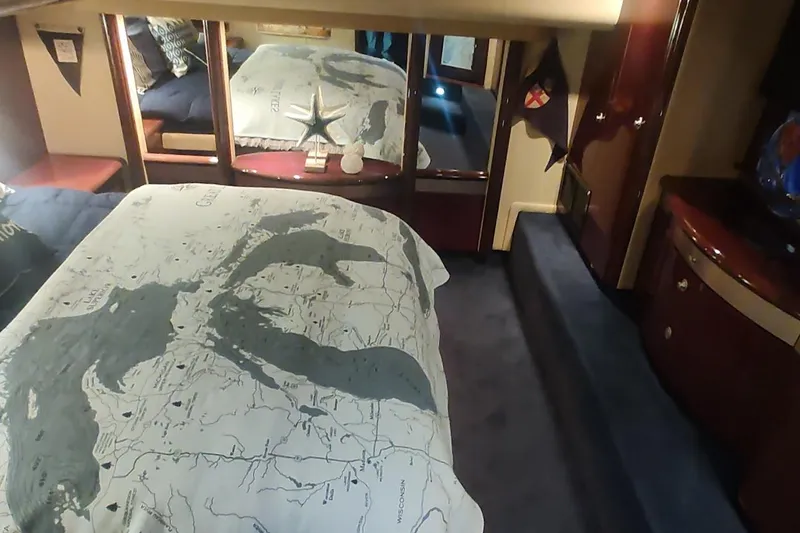 Slide: The Image of Luxurious 2007 Sea Ray 58 Sedan Bridge bedroom with nautical-themed decor. - 32