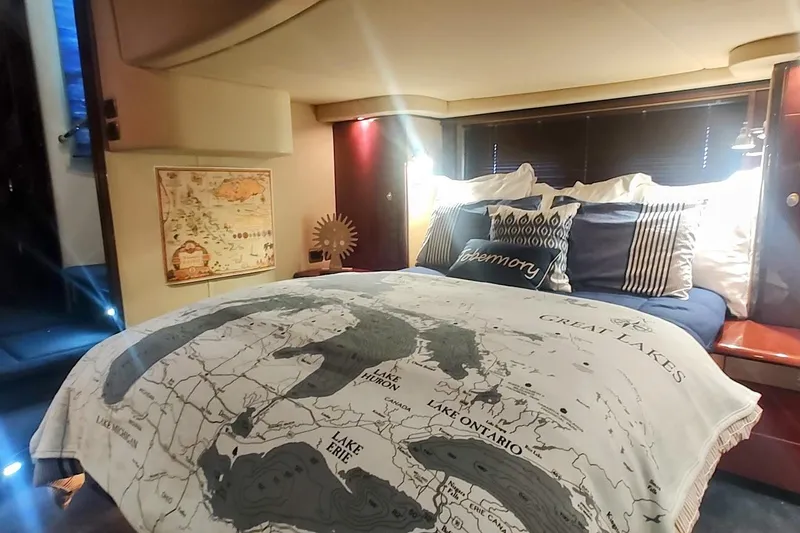Slide: The Image of Luxurious 2007 Sea Ray 58 Sedan Bridge bedroom with Great Lakes-themed bedding. - 33