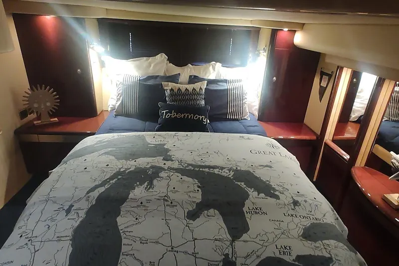Slide: The Image of Luxurious 2007 Sea Ray 58 Sedan Bridge bedroom with map-themed bedding and elegant decor. - 34