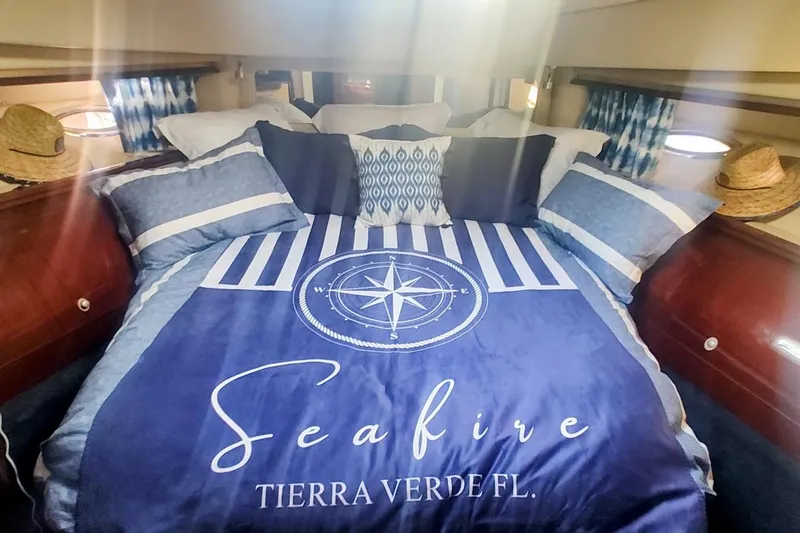 Slide: The Image of Luxurious 2007 Sea Ray 58 Sedan Bridge cabin with nautical-themed bedding. - 40