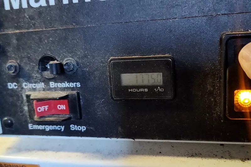 Slide: The Image of Control panel of a 2007 Sea Ray 58 Sedan Bridge with hour meter and switches. - 43