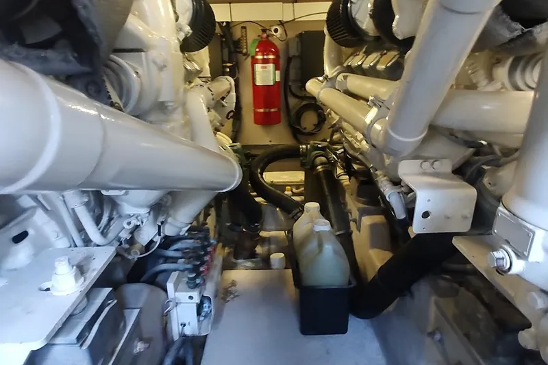 Slide: The Image of Engine room of a 2007 Sea Ray 58 Sedan Bridge with visible machinery and fire extinguisher. - 47