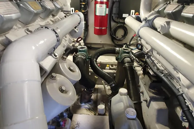 Slide: The Image of Engine room of 2007 Sea Ray 58 Sedan Bridge with visible pipes and fire extinguisher. - 49