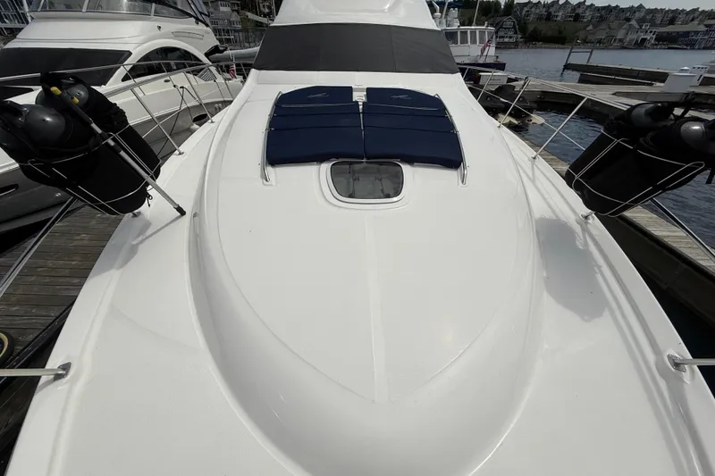 Slide: The Image of 2007 Sea Ray 58 Sedan Bridge yacht deck with sun pads at marina. - 7