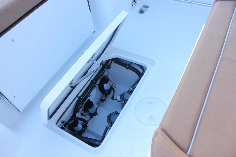 Slide: The Image of 2026 Sea Hunt Gamefish 28 Forward Seating boat interior with open storage compartment. - 10