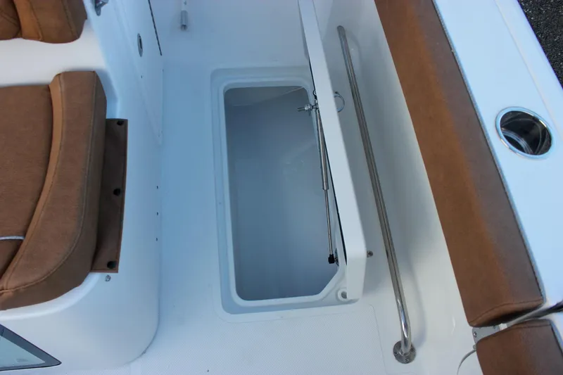 Slide: The Image of 2026 Sea Hunt Gamefish 28 Forward Seating boat interior with storage compartment and cushioned seats. - 13