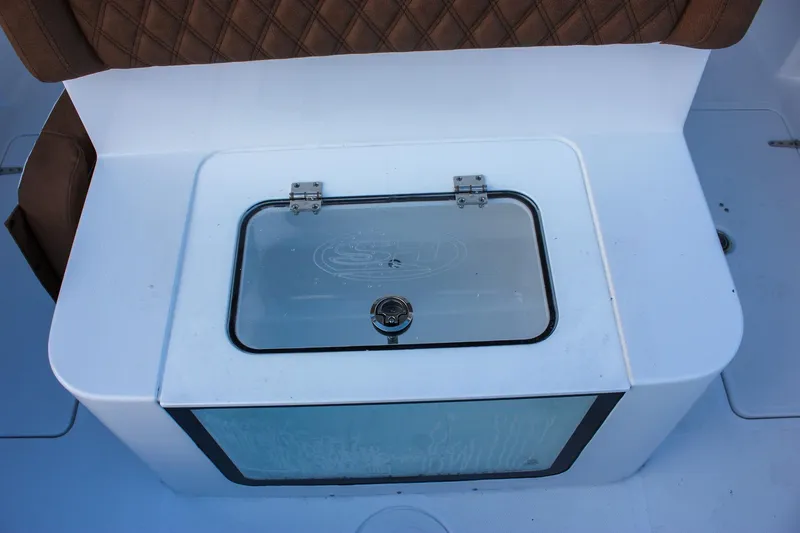 Slide: The Image of Livewell on 2026 Sea Hunt Gamefish 28 Forward Seating boat, featuring brown cushioned seating. - 14